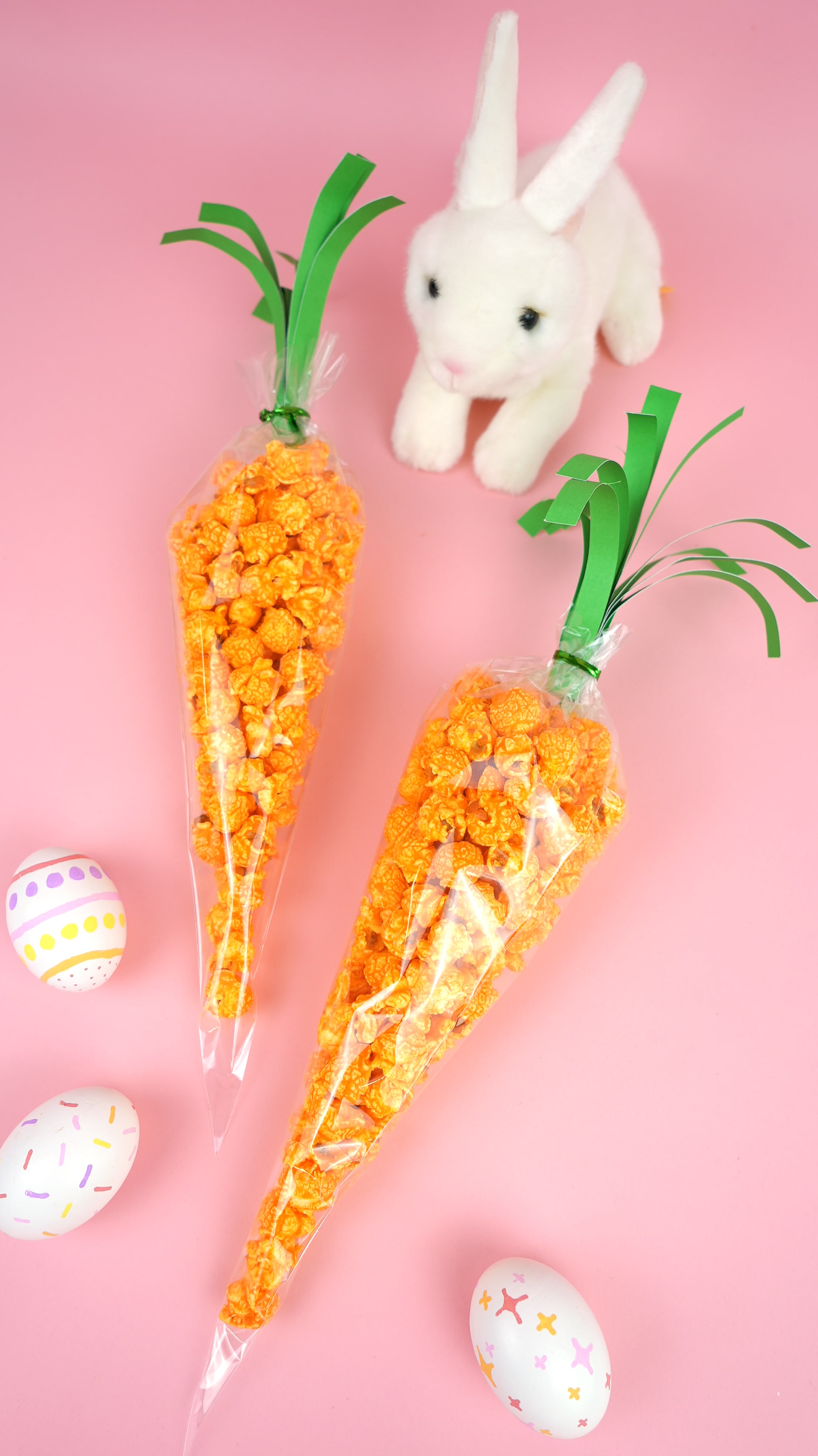 orange popcorn in treat bags shaped like carrots