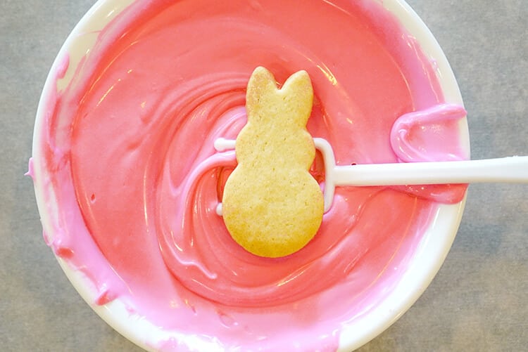 dipping cookies into pink candy melt 