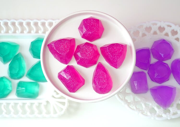 pink diy gemstone soaps on platter with other colorful soaps surrounding it 