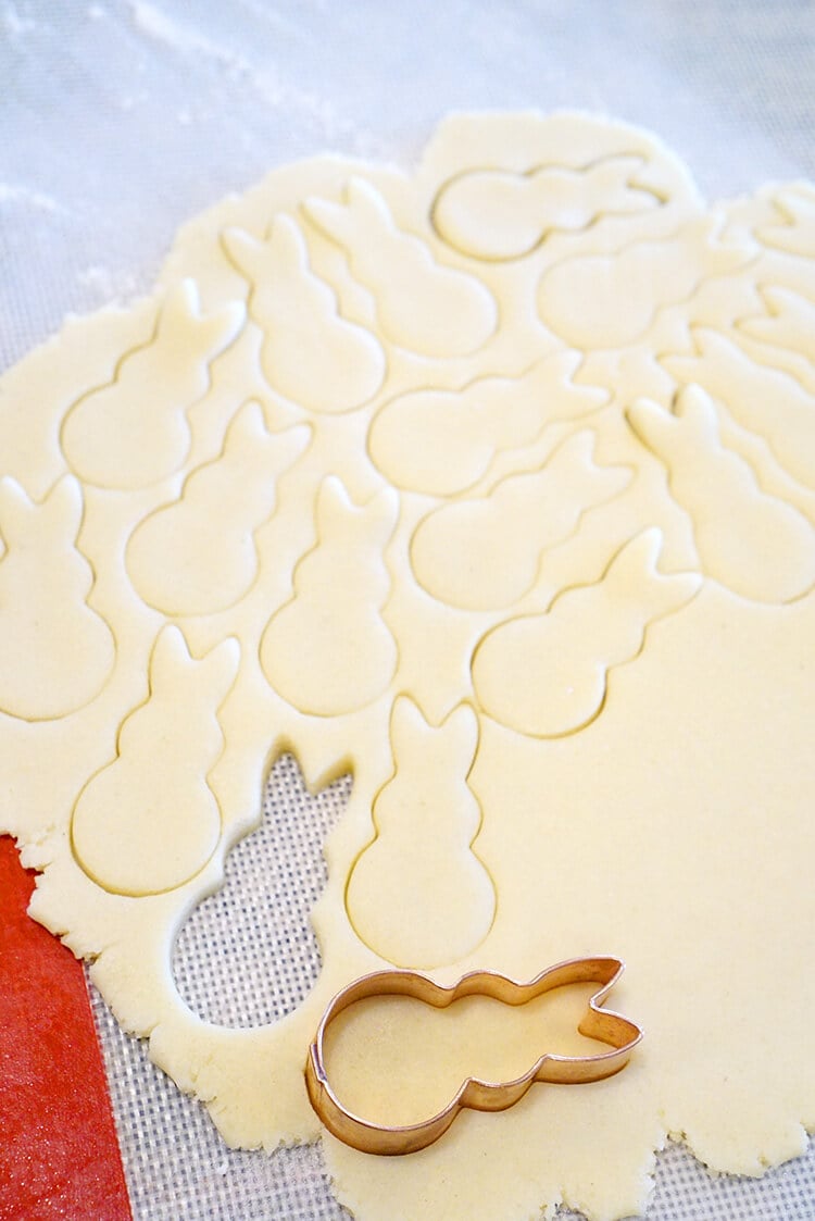cutting out sugar cookie bunnies from dough