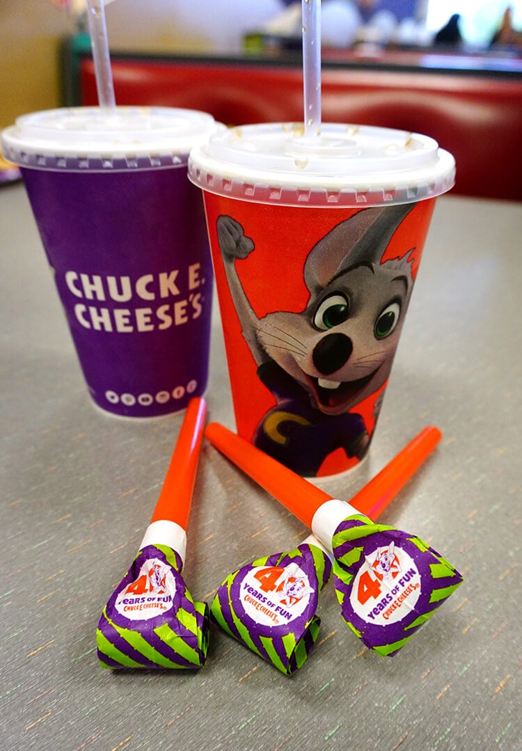 chuck e cheese\'s drink cups and party blowers