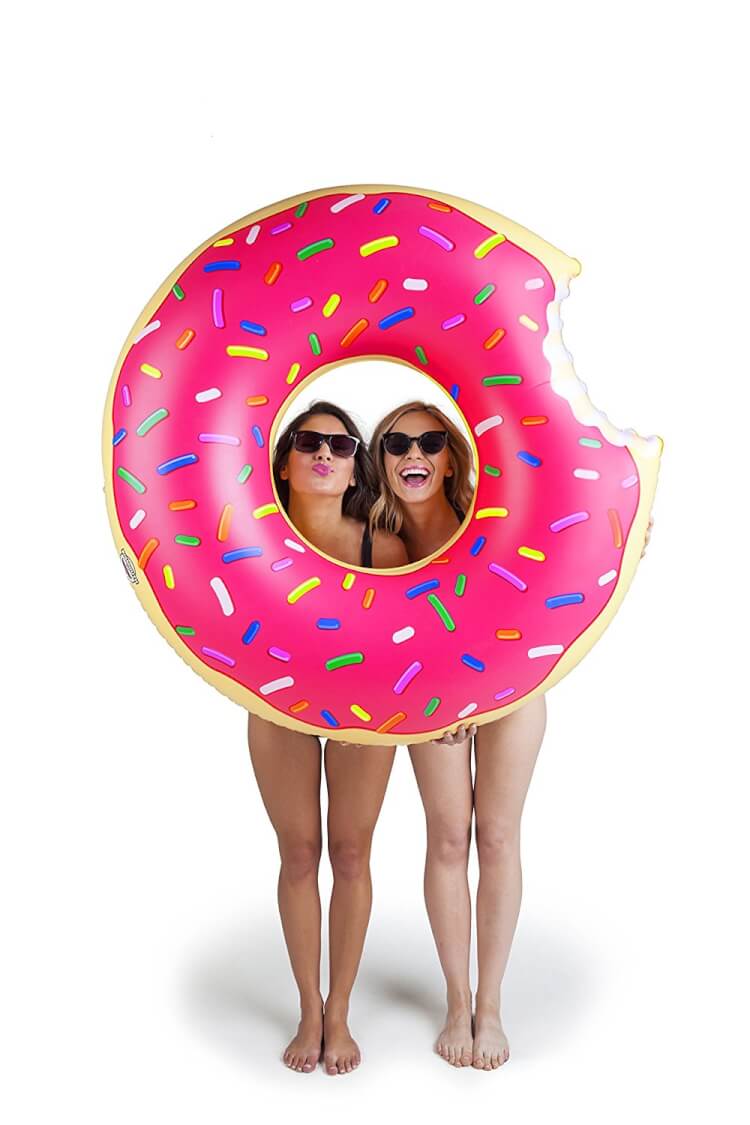 donut pool floaty held by two ladies