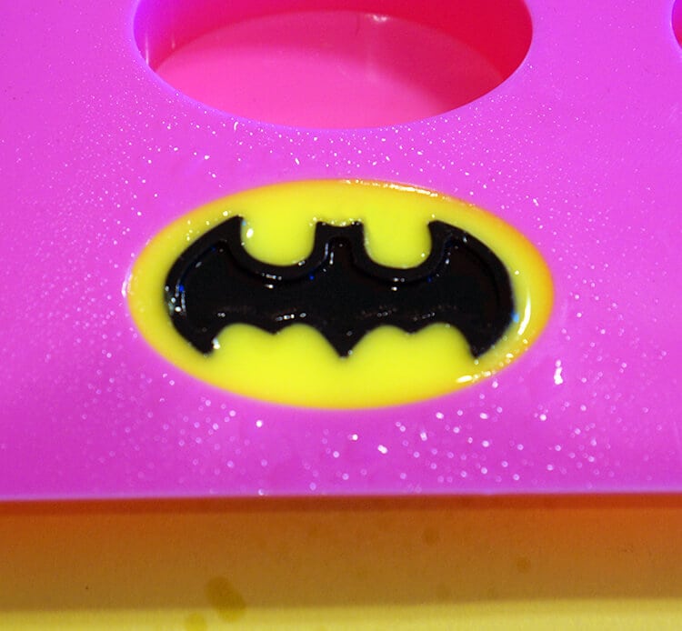 black bat symbol added to yellow soap in mold