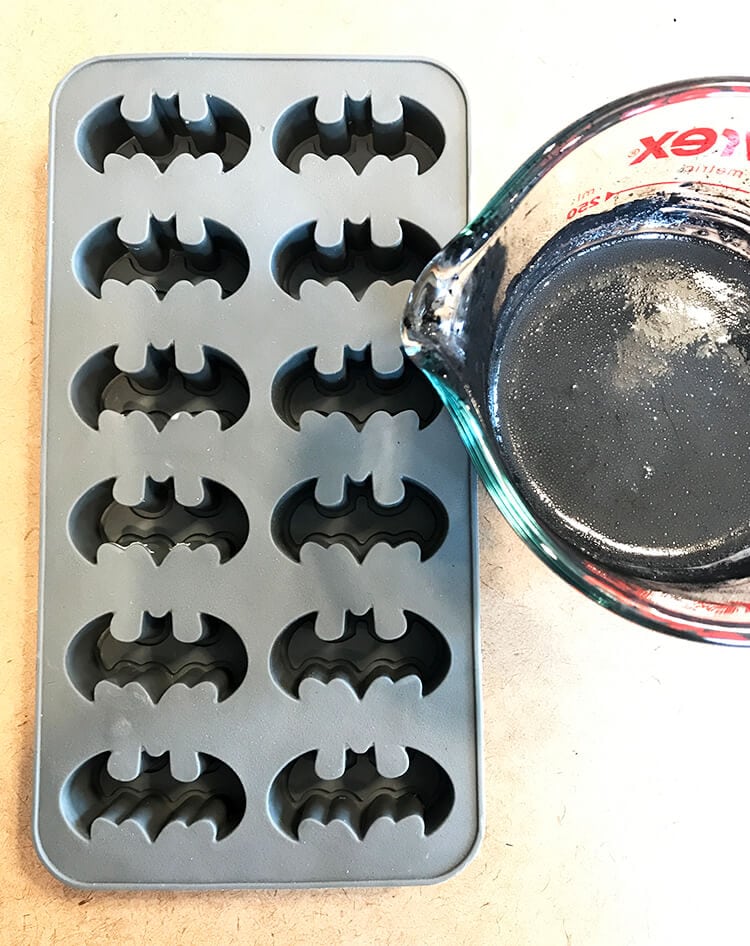 pouring soap mixture into batman symbols