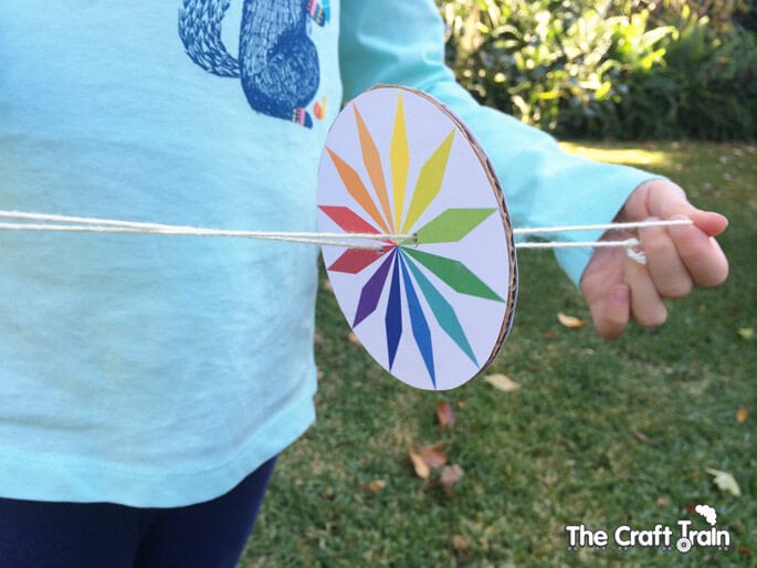 kid playing with DIY whirly gig