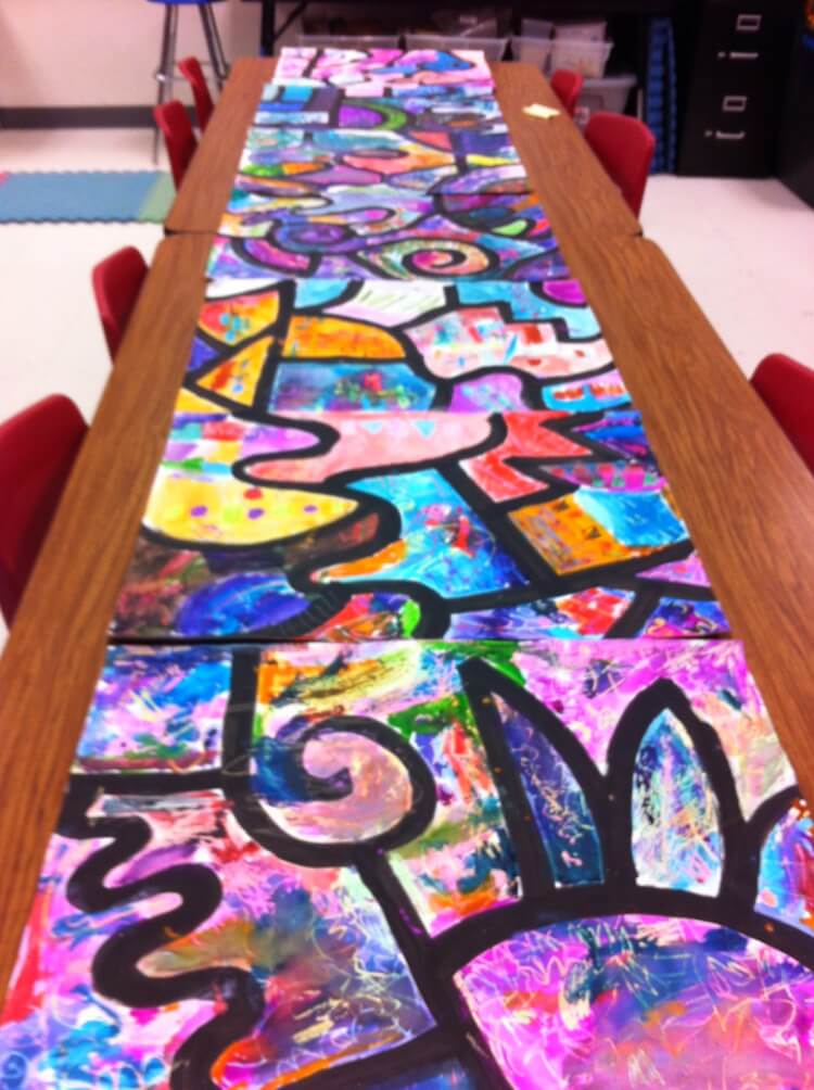 collaborative watercolor painting project on school tables