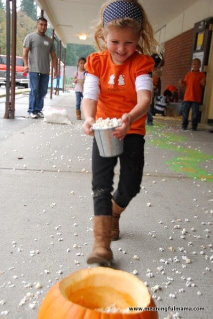 child racing to fill pumpkin