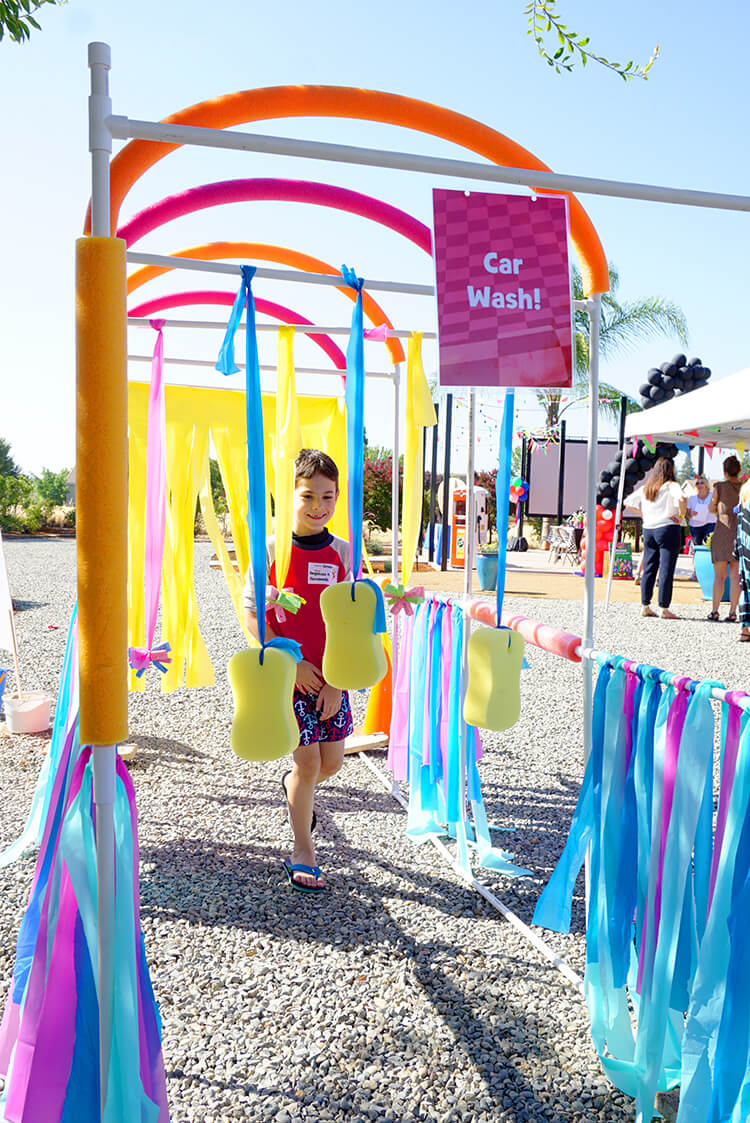 car wash sprinkler game being played by kids