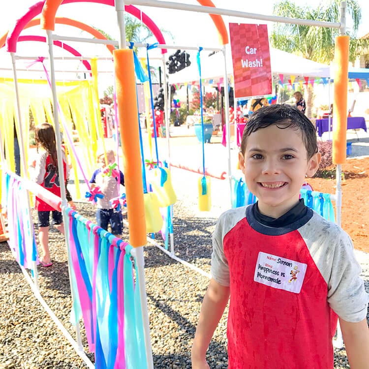 kid playing in car wash sprinklers game