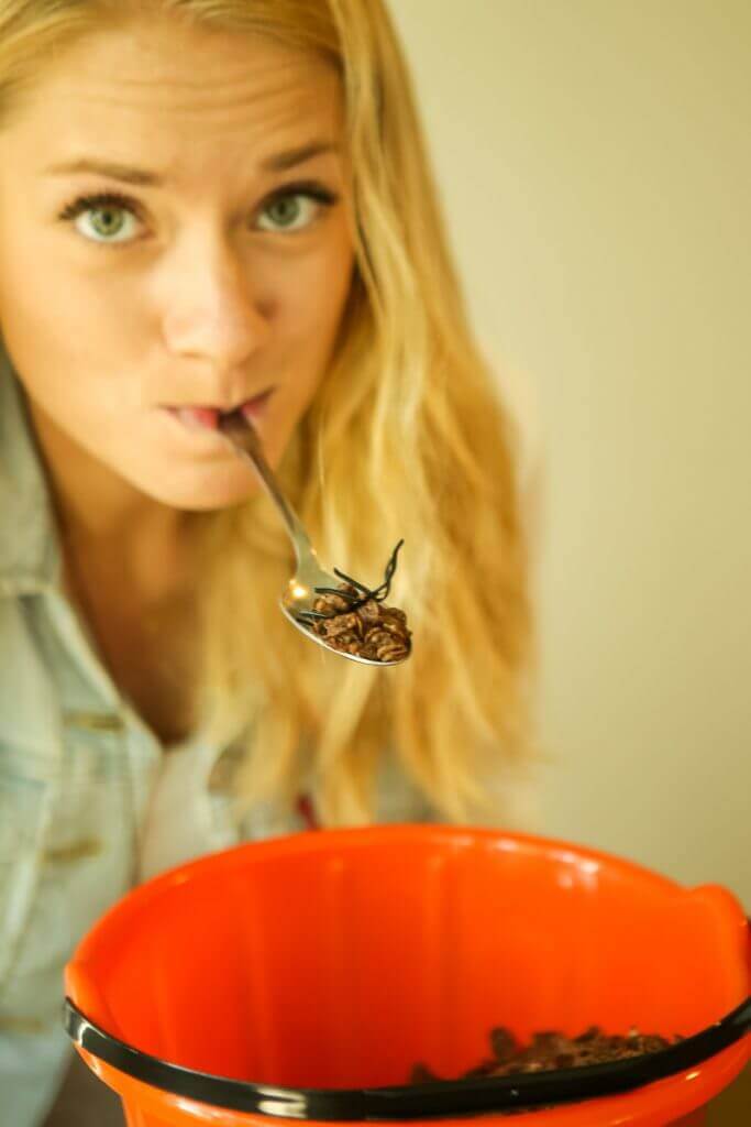 lady balancing cereal on a spoon hanging from her mouth