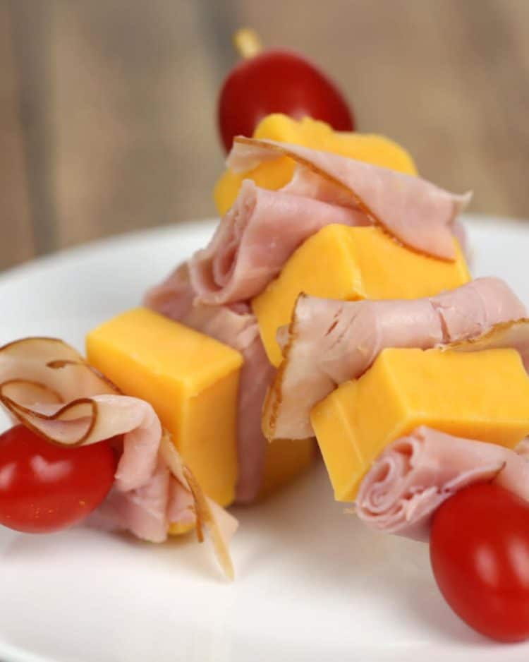 School Lunch Ideas for Kids - lunch kabobs of skewered tomatoes, cheese, and deli meat on a white plate