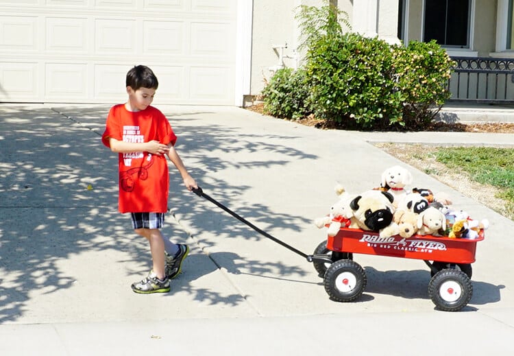 radio flyer wagon being pulled by young boy