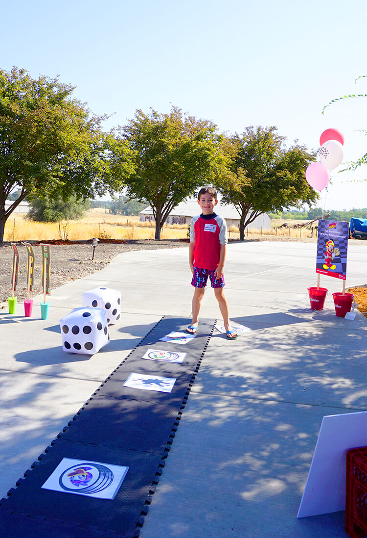 kid playing life sized trophy triumph game