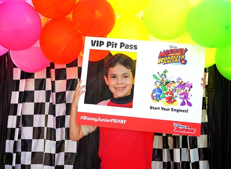 kid taking picture in vip pit pass photo prop