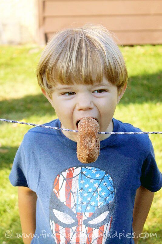 kids playing donut munching game 