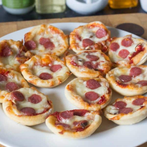 13 mini pepperoni pizza bites on a white plate