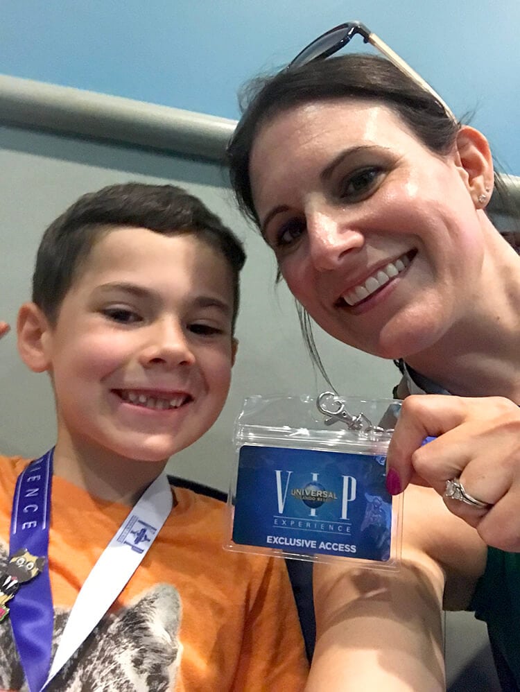 family posing with VIP badge for universal studios