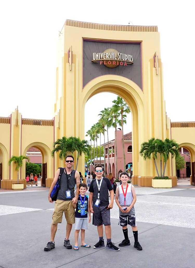 family posing in front of entrance to universal studios florida