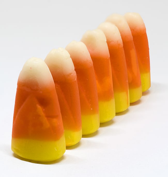 candy corn standing on one end in a line
