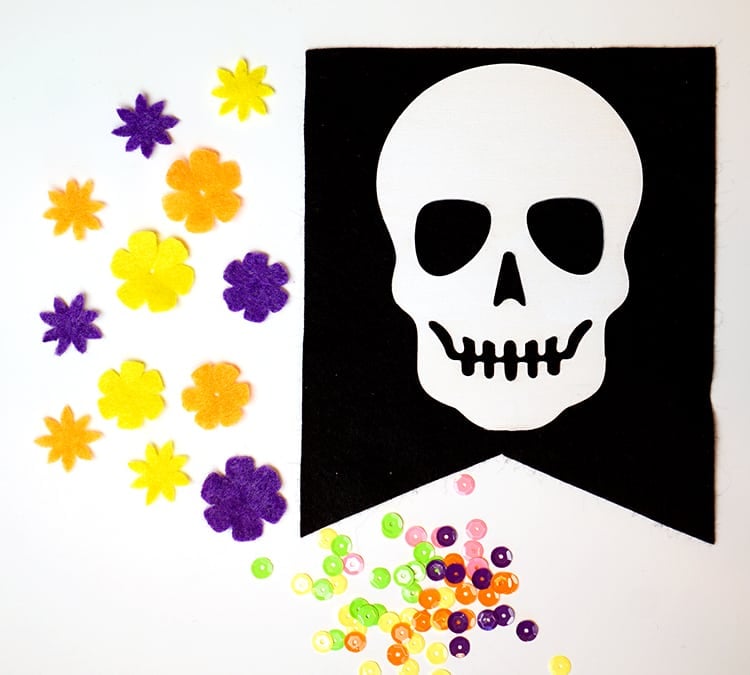 skull cut out for banner with felt flowers and buttons