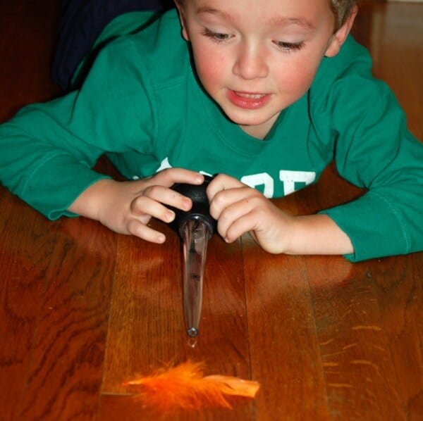 kids playing game with turkey baster and feather