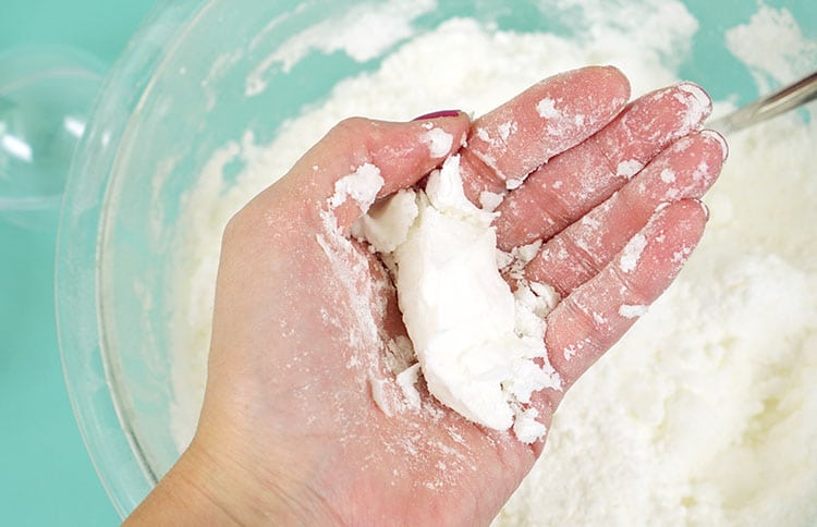 compacting bath bomb mixture in hands