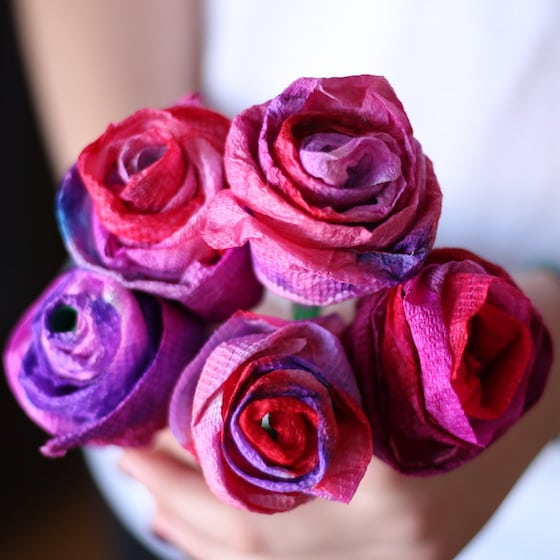hands holding bouquet of colorful paper towel roses