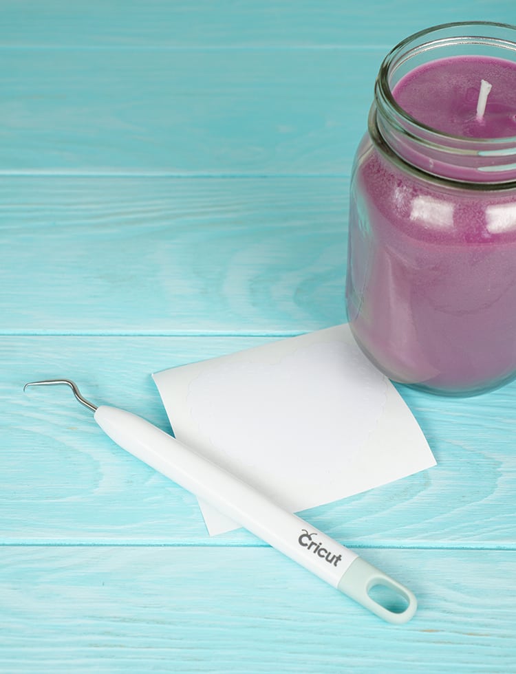 purple wax candle in mason jar and cricut tools