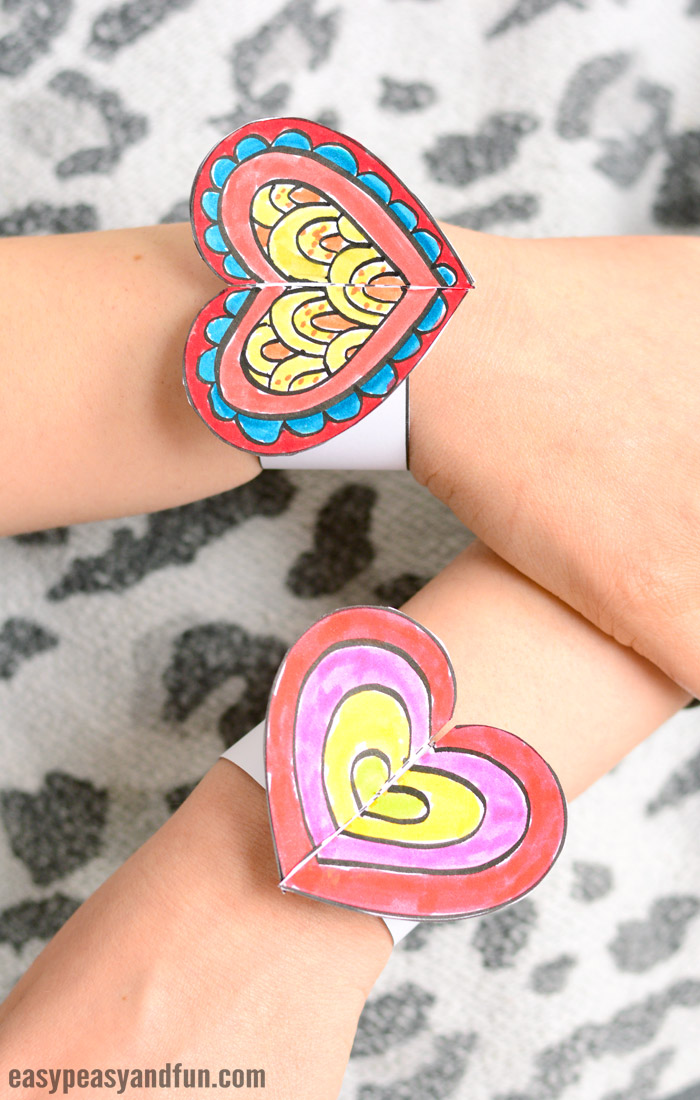 hands showing off printable heart paper bracelets