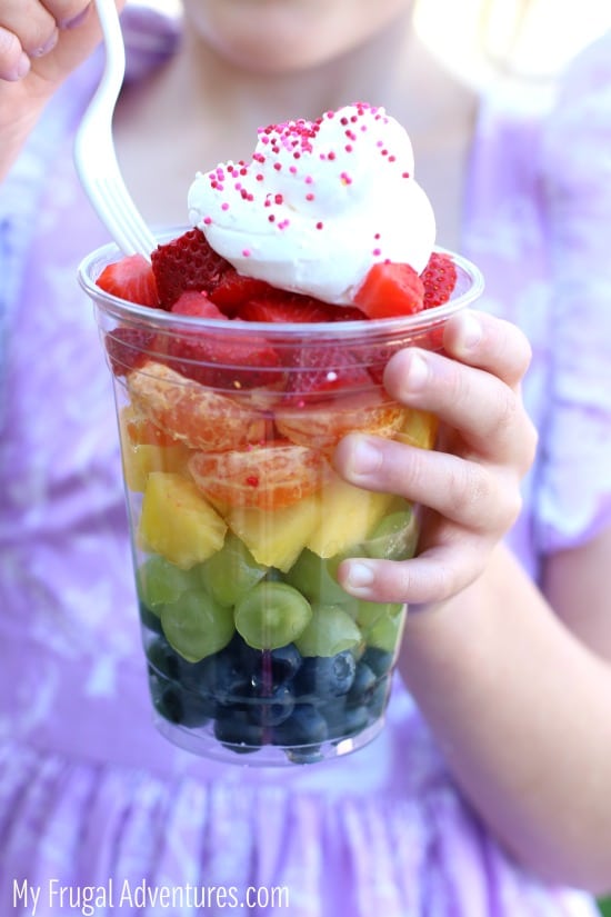 rainbow fruit cup dessert with whipped cream topping