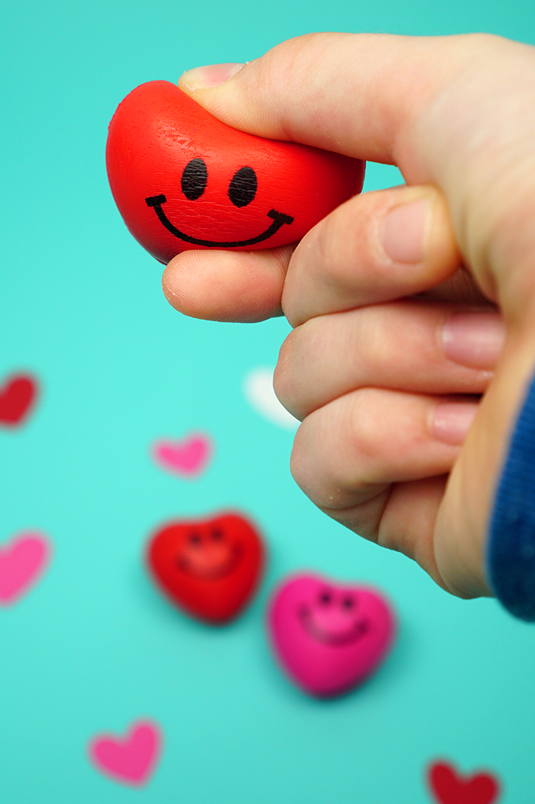 squishing heart toy in hands