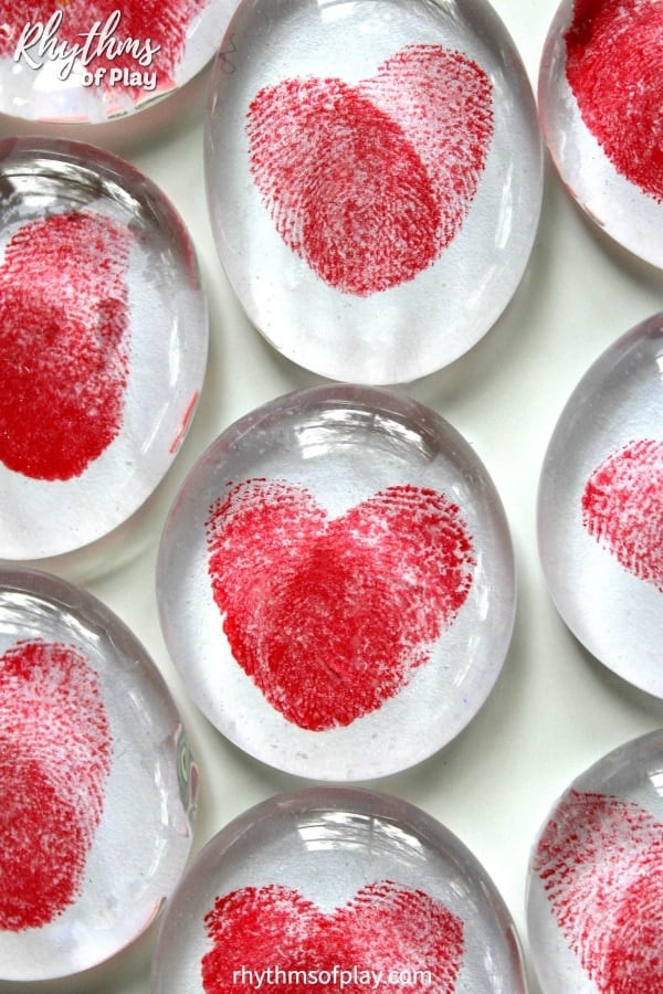 thumbprint and heart magnets on glass