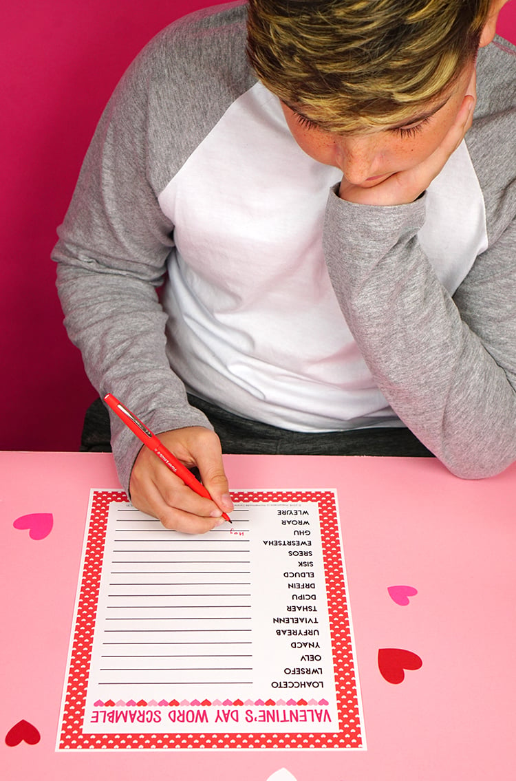 printable Valentine\'s Day Word Scramble game being played by boy