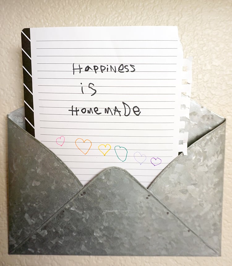 happiness is homemade written on notebook paper in metal envelope 