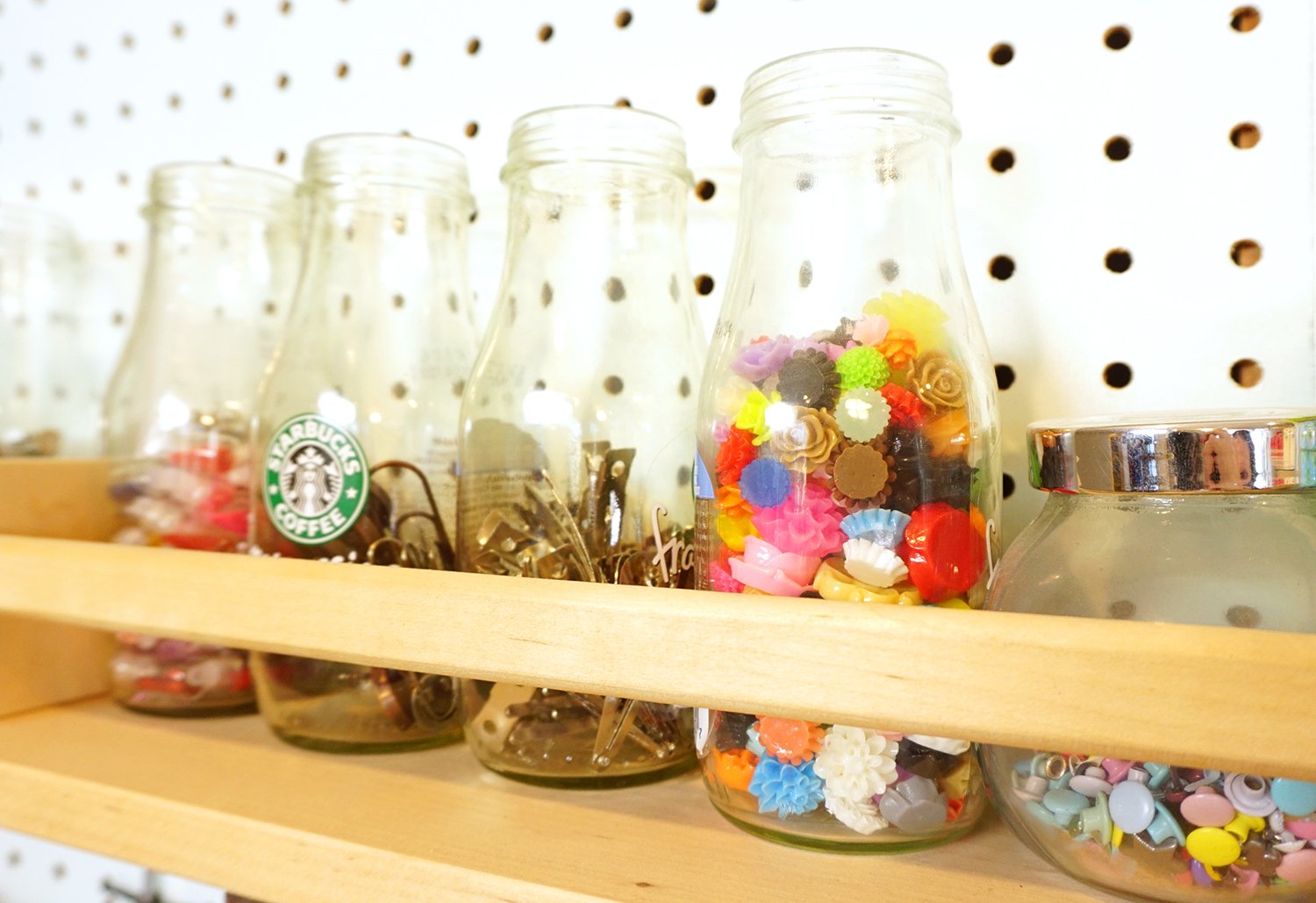 starbucks bottles with craft supplies inside of them