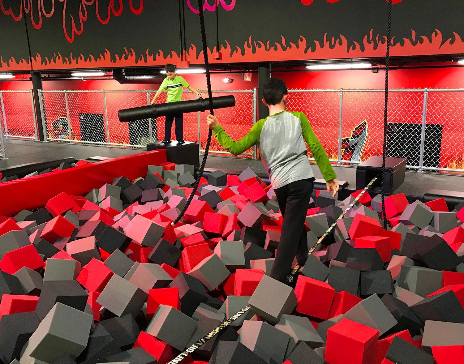balance beams with foam pit being walked by kid