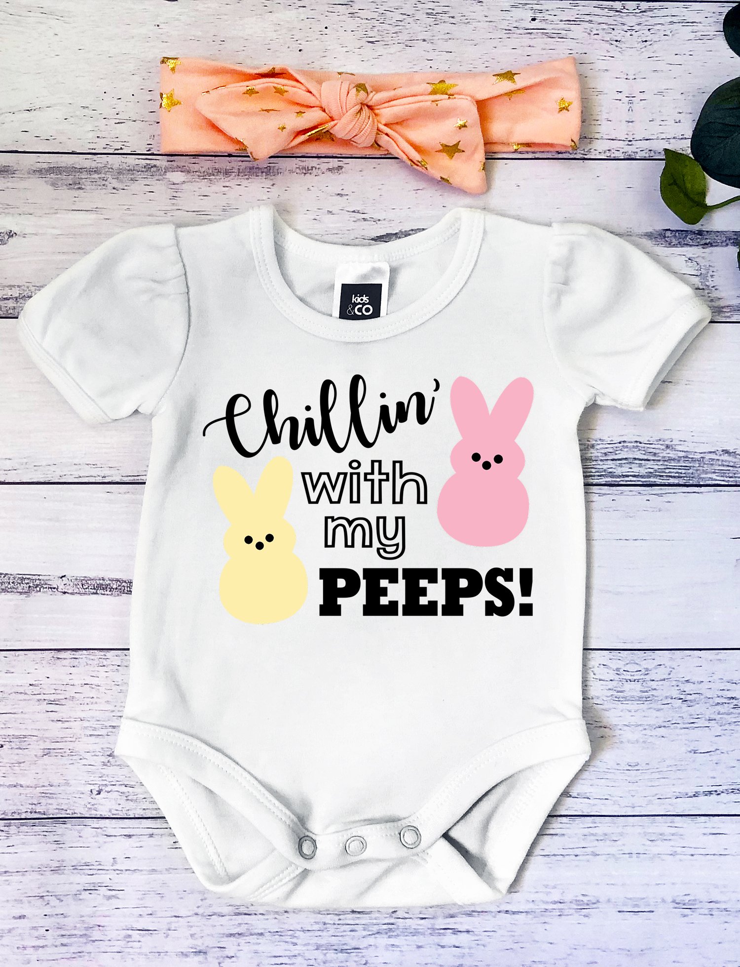 White baby onesie with "Chillin' with My Peeps" design and peach hair bow - Easter SVG file