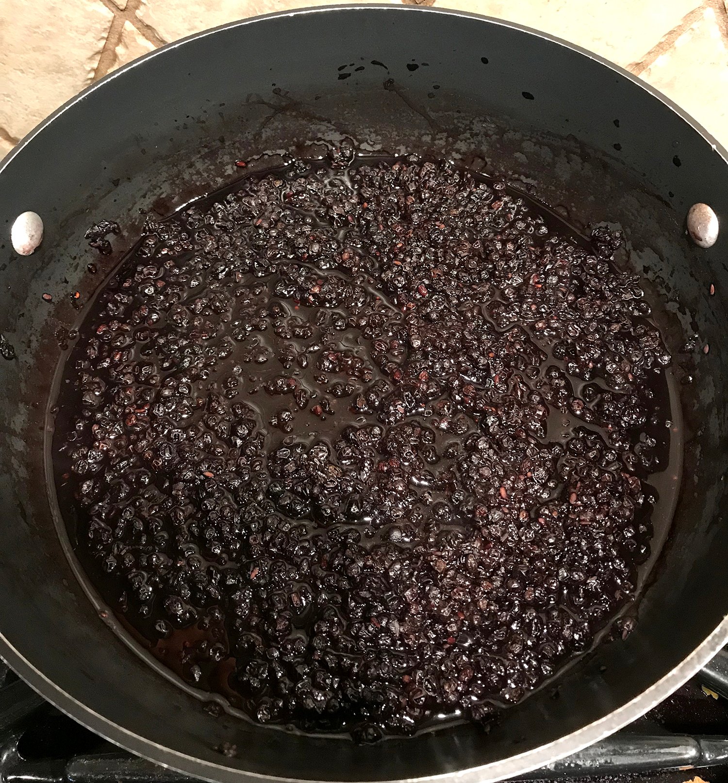 cooked elderberries in pan