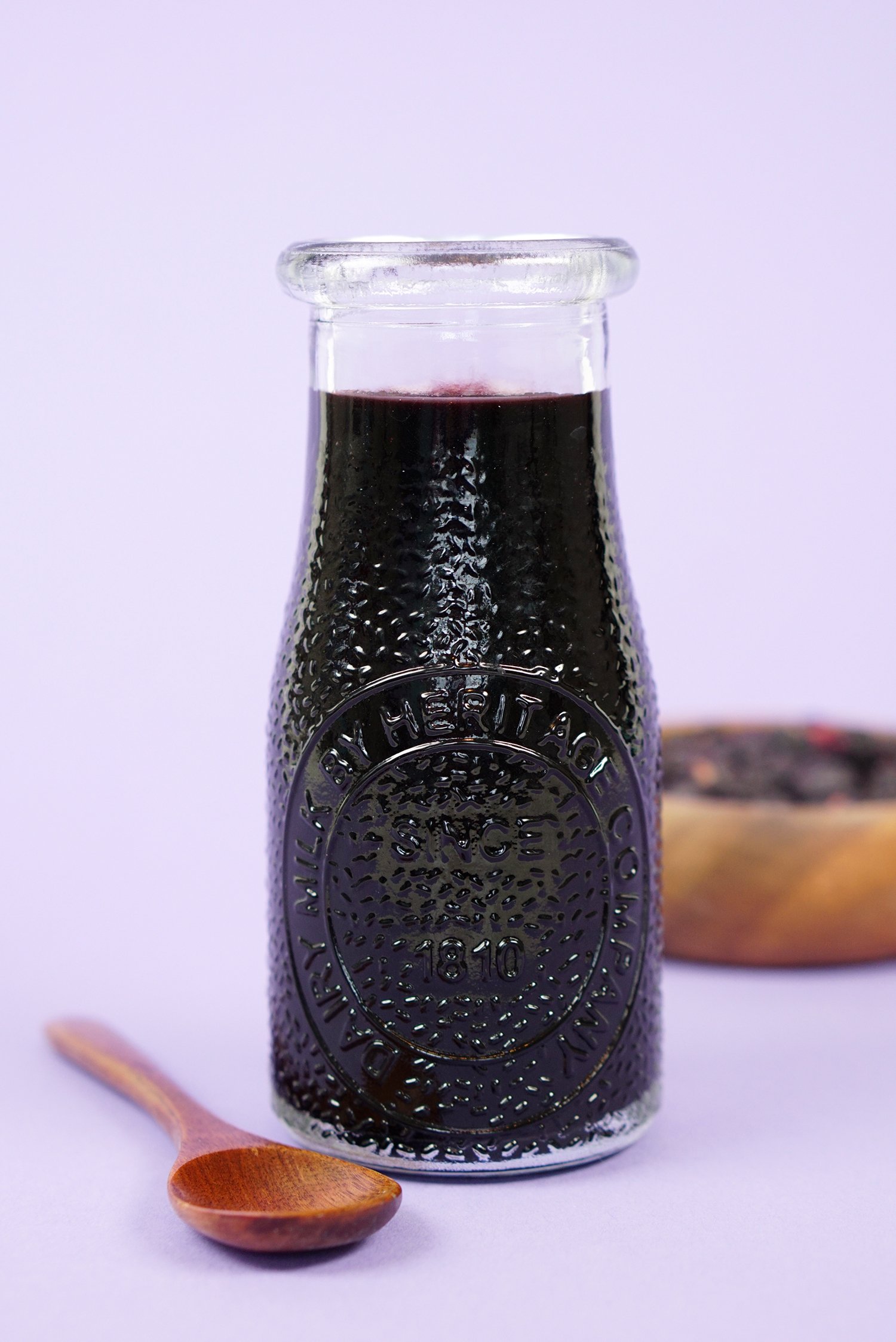 elderberry syrup in jar with spoon