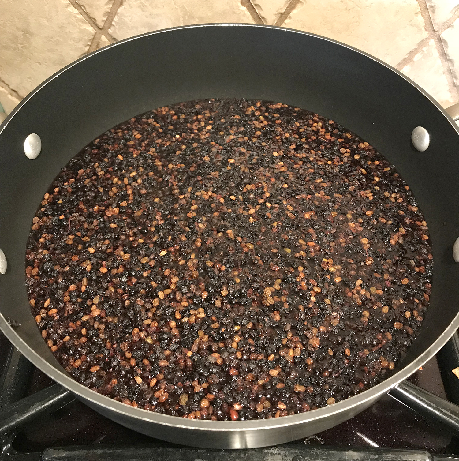 dried elderberries in pot on stove