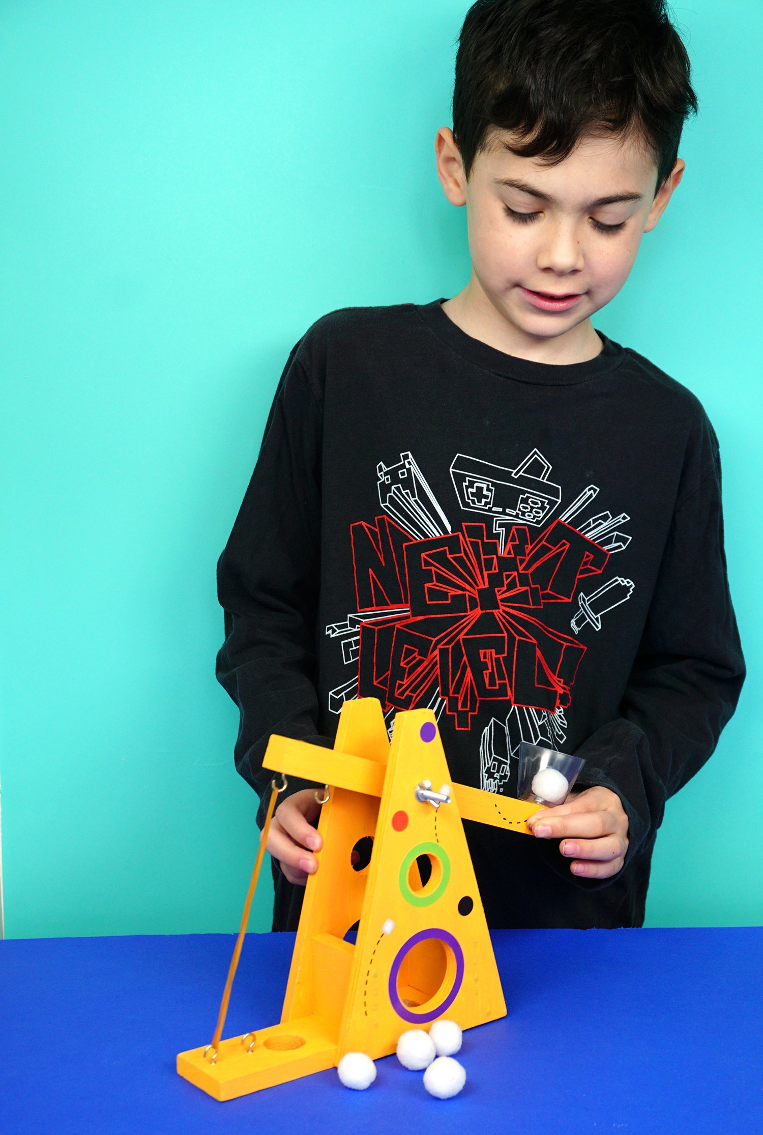 child playing with marshmallow launcher 