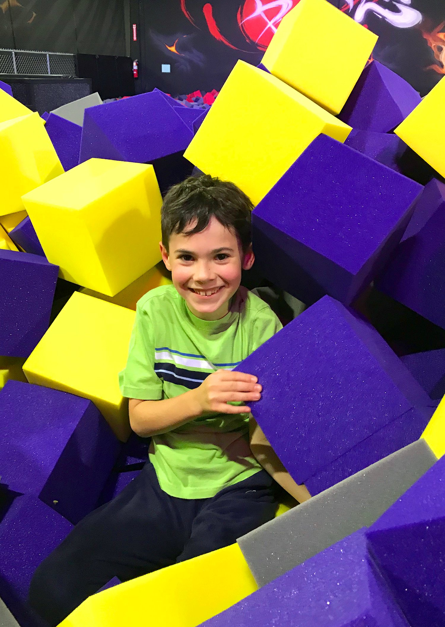 mojo dojo foam pit with smiling boy inside playing