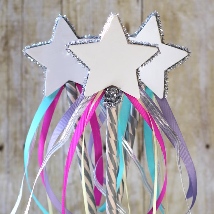 Three star-shaped wands with colorful ribbons