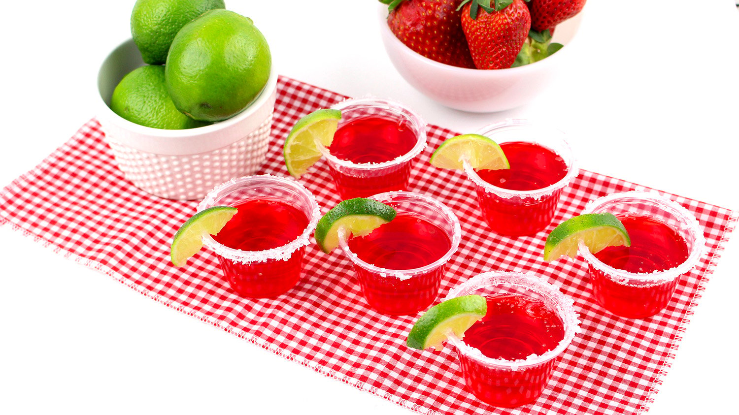 strawberry margarita jello shots with bowl of limes