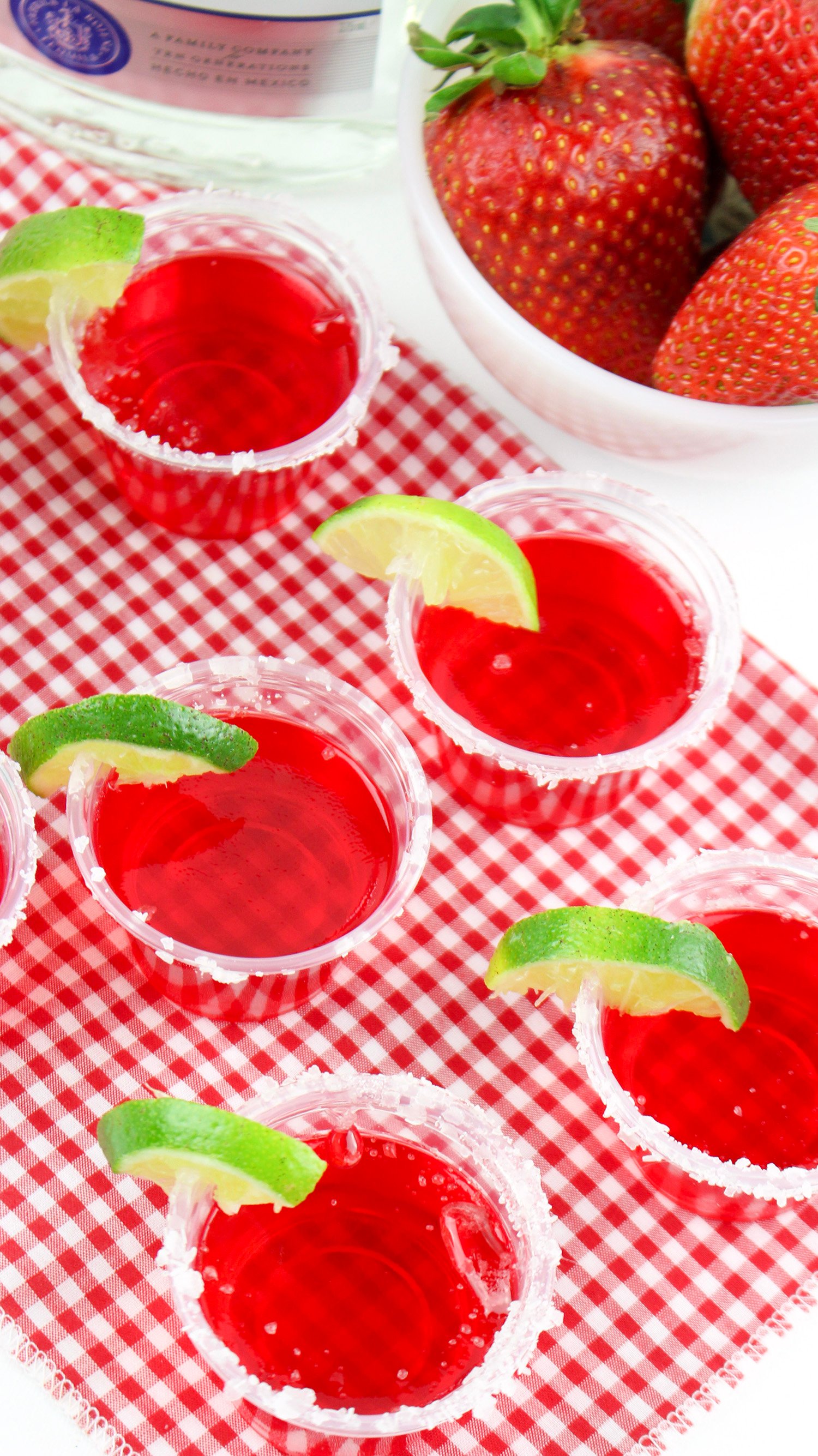 strawberry margarita jello shots on red gingham background