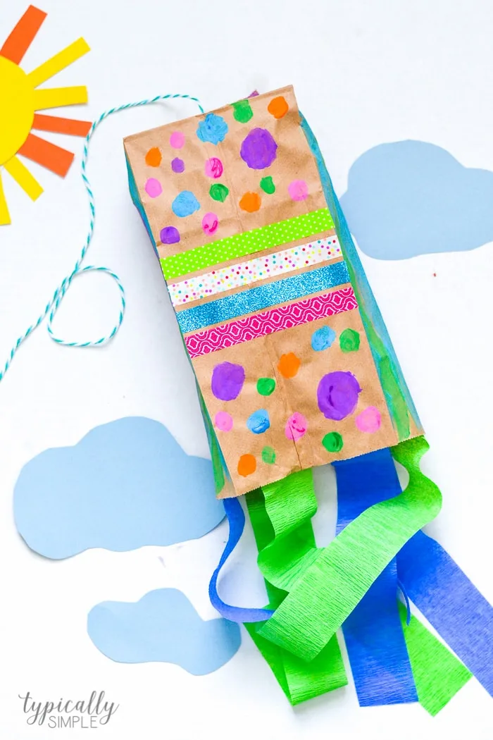 Colorful Paper Bag Kite with streamers on a construction paper "sky" background