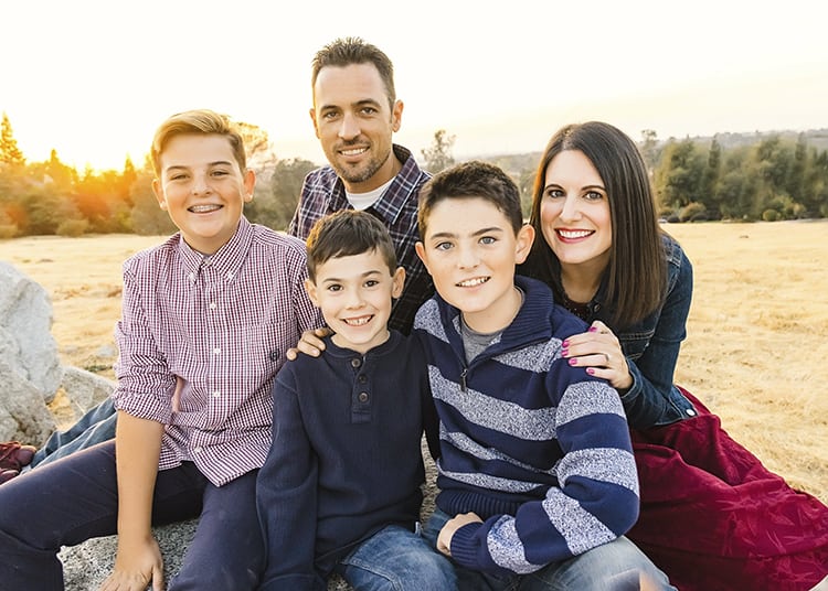 heidi kundin from Happiness is Homemade posing with husband and 3 sons