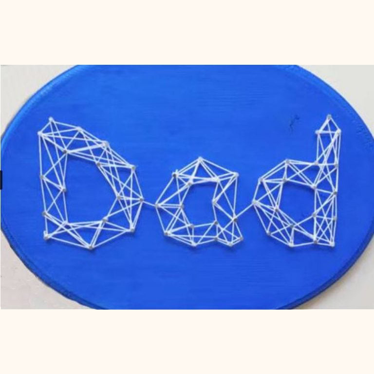 Close up of blue plaque with "Dad" string art in white yarn