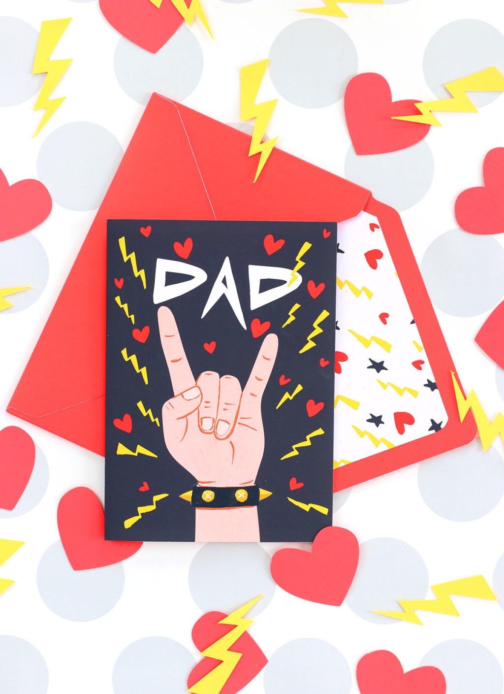 Dad card with hand holding rock on symbol on card 