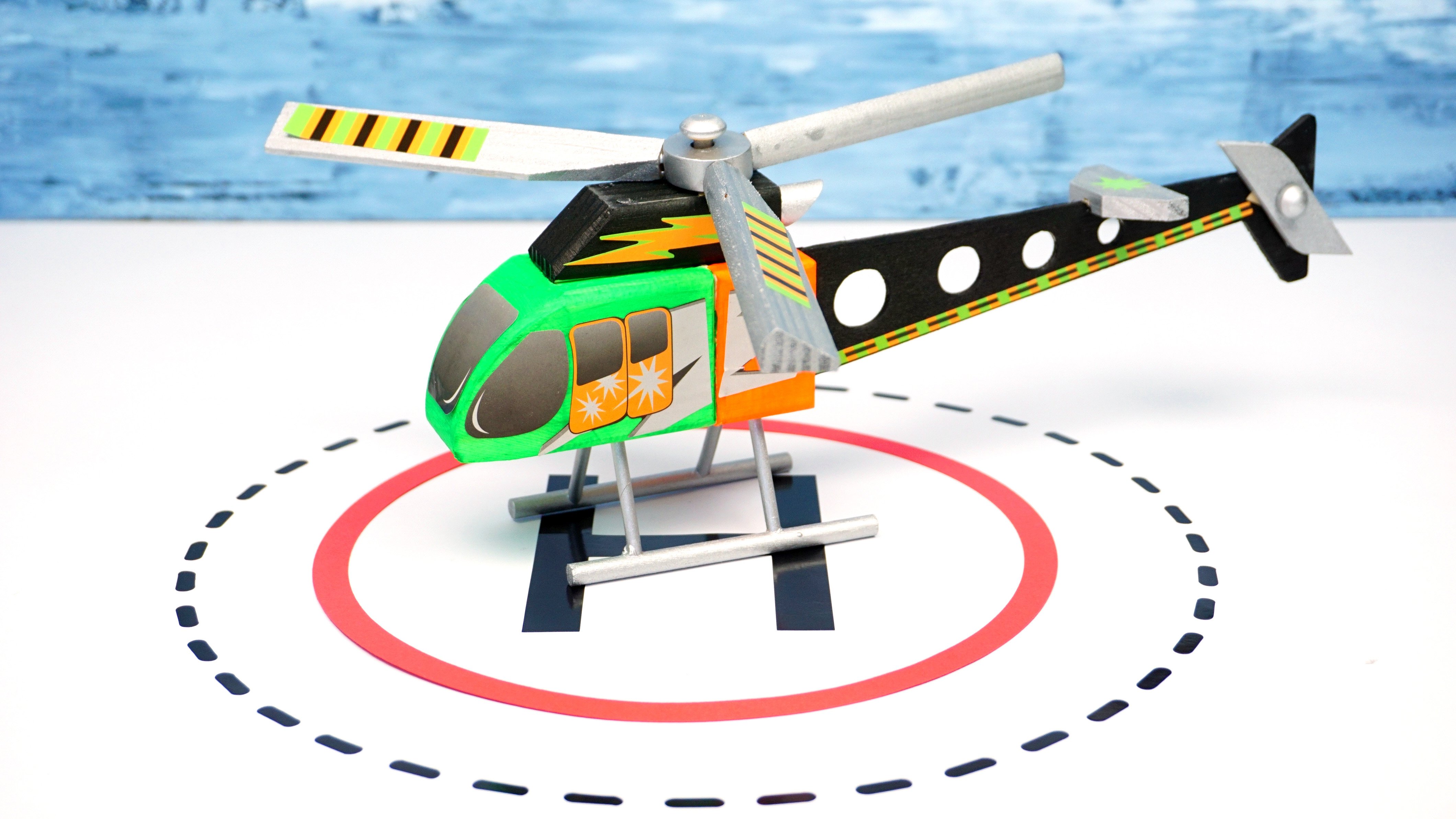 helicopter toy painted and assembled on landing pad